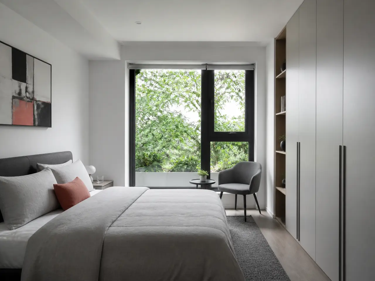 Calm neutral apartment bedroom with a planted garden outlook